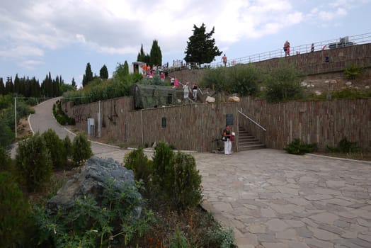 concrete stairs to enter the terrace where there is a large number of vacationers