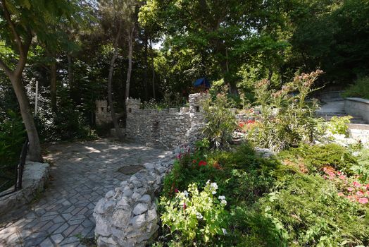 magnificent flower bed decor made in the form of the walls of an old castle with towers very beautiful and original