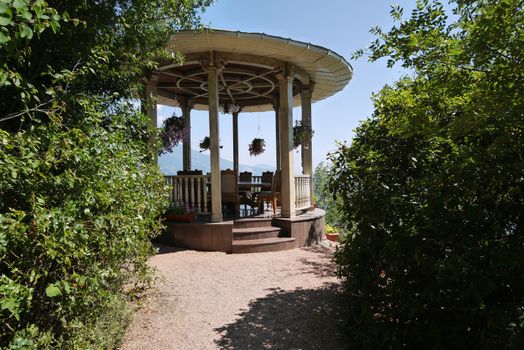 A beautiful small table with a cover in the park on the background of a beautiful mountain landscape