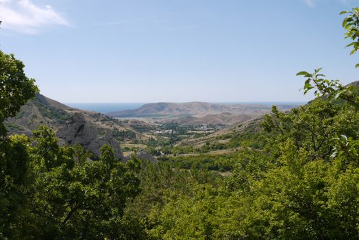 Wonderful view of the mountain ranges, green valleys and blue lake in the distance