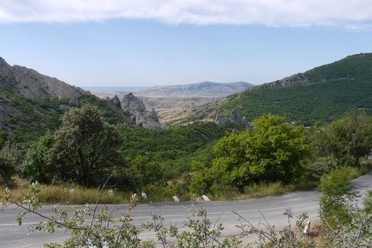 Beautiful scenery on the green mountains and valleys stretching into the distance to the horizon line. The beauty of the wild nature from which not to tear one's eyes.