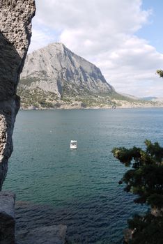 A view from the gorge in the rock to the mountain located on the opposite side of the bay