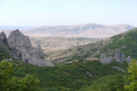 Scenic view of the valley at the foot of the high rocky mountains