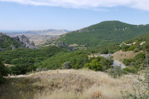 mountains covered with a green carpet of forests stretching to the horizon