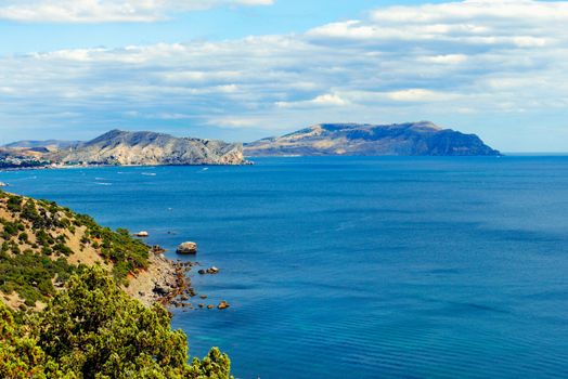 Boundlessly bright blue sea against the backdrop of rocky mountain islands