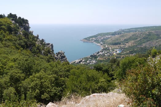 a small cozy town under a blue sky on the shores of a huge black sea