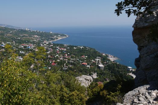 small grass-covered rocks on the background of a beautiful coastal town