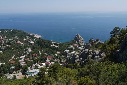 small grass-covered rocks on the background of a beautiful coastal town