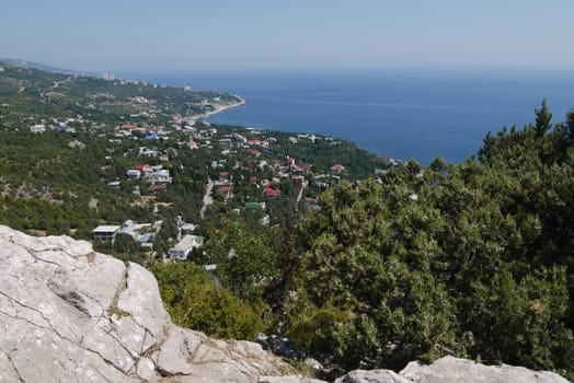 small grass-covered rocks on the background of a beautiful coastal town