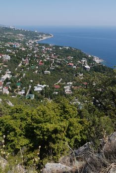 small grass-covered rocks on the background of a beautiful coastal town