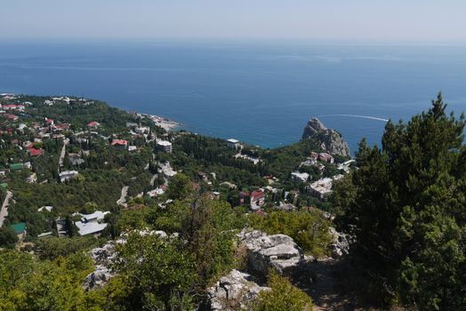 small grass-covered rocks on the background of a beautiful coastal town