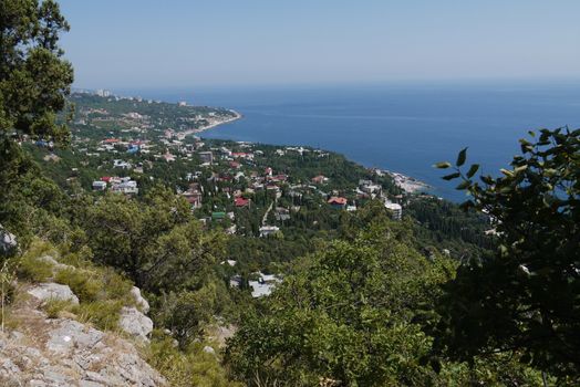 small grass-covered rocks on the background of a beautiful coastal town