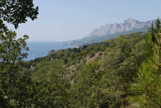 grass slopes on the background of high steep cliffs and the boundless black sea