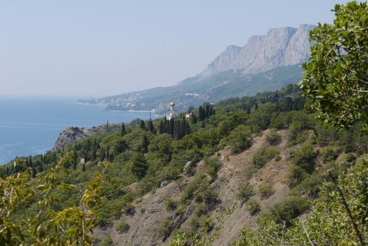 grass slopes on the background of high steep cliffs and the boundless black sea