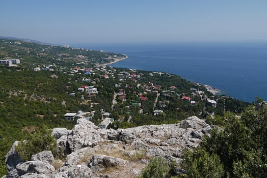 small grass-covered rocks on the background of a beautiful coastal town