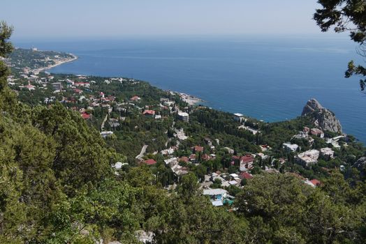 a quiet coastal town under a blue sky on the background of the boundless sea