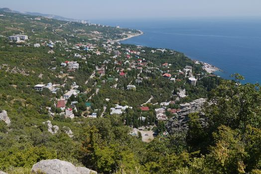 small grass-covered rocks on the background of a beautiful coastal town