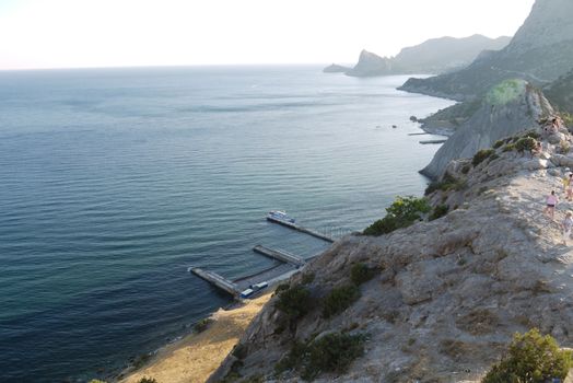 High, beautiful mountains on the shore of a deep black sea