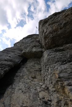 steep tall cliffs under the cloudy blue sky