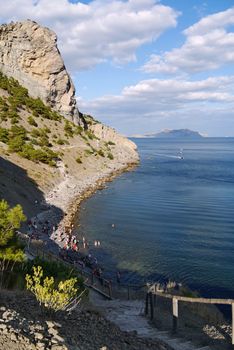 beautiful Crimean slopes on the shore of the Black sea.Tipping on the beach