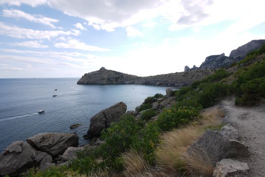 narrow rocky track on the background of a large deep bay