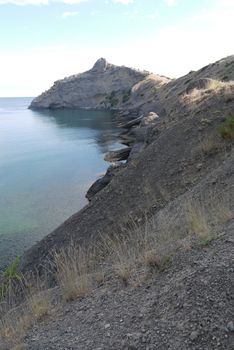 High, beautiful mountains on the shore of a deep black sea