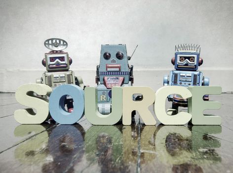 team of robots and the word source on a old wooden floor