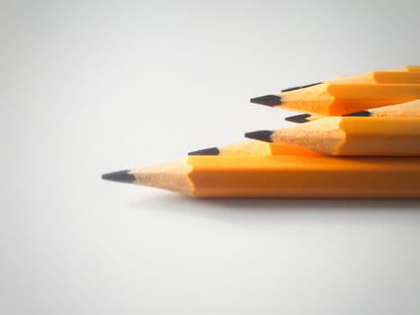 Group of yellow pencils on a white plane