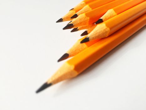 Group of yellow pencils on a white plane