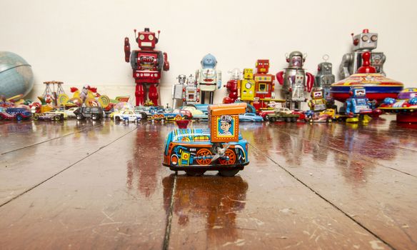 small  tin toy train on wooden floor