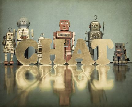 vintage robot toys with the word CHAT on an old fooden floor 