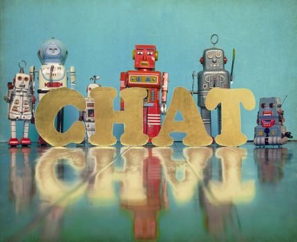 vintage robot toys with the word CHAT on an old fooden floor 