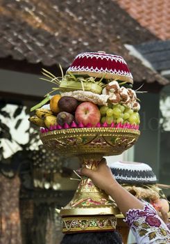 girl  with a bowel of fruit on her head bali