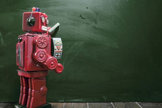 vintage robot writes on black board 