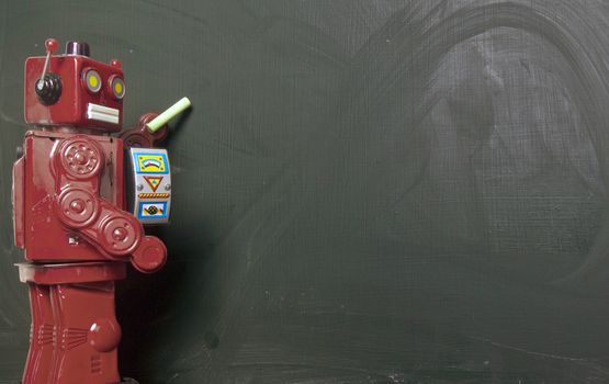 vintage robot writes on black board 