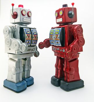 two retro robots meet and shake hands 