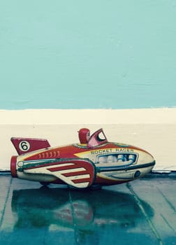 retro rocket toy on wooden floor  with reflection 