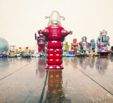 red robot standing on old wooden floor
