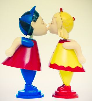 two old plastic toys kissing