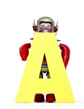 capital letter A held by vintage robot toys 