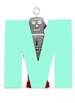 capital letter M held by vintage robot toys 