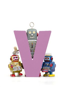 capital letter V  held by vintage robot toys 