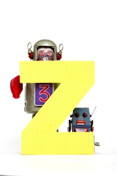 capital letter Z  held by vintage robot toys 