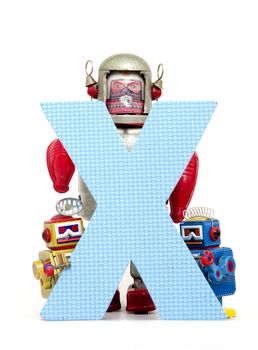 capital letter X held by vintage robot toys 