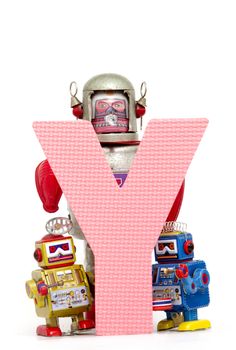 capital letter  Y held by vintage robot toys 