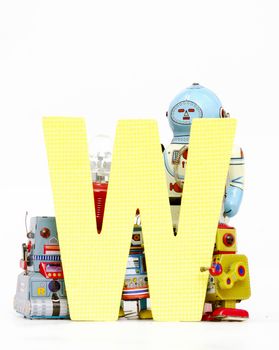 capital letter W  held by vintage robot toys 