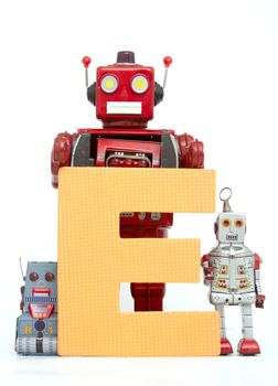 capital letter E held by vintage robot toys 