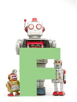 capital letter F  held by vintage robot toys 