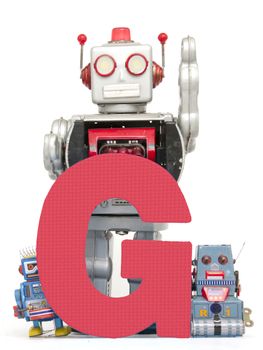 capital letter G  held by vintage robot toys 