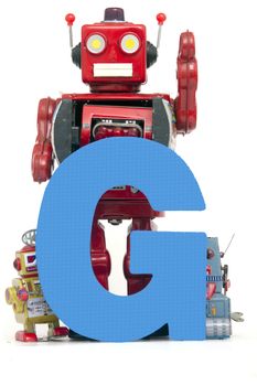 capital letter G held by vintage robot toys 